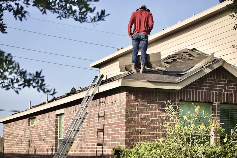 Professional roofer working on a residential roof in Oakland Mills